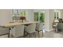 Elegant dining room with large window and sliding glass doors with natural light at 4699 Sw 88Th Ln, Ocala, FL 34476