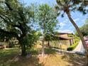 Condo exterior featuring mature trees, a walkway, and manicured landscaping at 519 Fairways Cir # A, Ocala, FL 34472