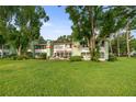 The backyard features mature trees offering shade and an inviting patio to relax and enjoy the view at 546 Midway Dr # B, Ocala, FL 34472