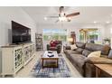 Cozy living room with tile flooring, ceiling fan, decorative rug, and comfortable furniture at 6394 Sw 97Th Terrace Rd, Ocala, FL 34481