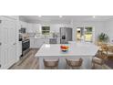 Modern kitchen with stainless steel appliances, white cabinets, and quartz countertops at 6689 Nw 61St St, Ocala, FL 34482