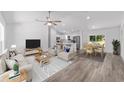 Inviting living room with an open concept, light wood floors, and neutral-toned furnishings at 6689 Nw 61St St, Ocala, FL 34482