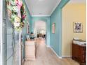 Inviting foyer featuring archway, decorative floral wreath and decor, leading to a light-filled living space at 6868 Sw 95Th Cir, Ocala, FL 34481