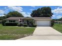 Attractive home with a front-entry garage, charming front porch, and mature landscaping at 8244 Sw 106Th Pl, Ocala, FL 34481
