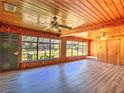 Bright living room with wood paneled walls, plenty of natural light and ceiling fans to keep you cool at 834 Ne 10Th Ave, Ocala, FL 34470