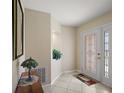 Inviting foyer with a decorative glass door, tiled floor, and plant nook at 8617 Se 141St Street Rd, Summerfield, FL 34491