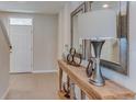 Inviting entryway featuring a console table with decorative accents, mirrors, and tiled flooring at 8659 Sw 44Th Ter, Ocala, FL 34476