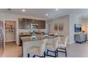 Modern kitchen with stainless steel appliances, granite countertops, and a convenient breakfast bar at 8659 Sw 44Th Ter, Ocala, FL 34476