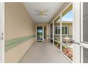 A screened-in porch with a ceiling fan offers a pleasant outdoor space for relaxing or greeting visitors at 9958 Sw 59Th Cir, Ocala, FL 34476
