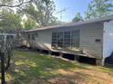 This home has a wide side yard, large picture windows, and an elevated foundation at 1004 Ne 71St Ln, Ocala, FL 34479