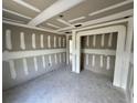 Bedroom showcasing unfinished drywall, smooth concrete floors, and open doorway at 1057 Nw 68Th Pl, Ocala, FL 34474