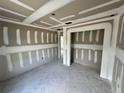 Interior of room shows freshly installed drywall and tape awaiting paint, featuring recessed ceiling lights at 1057 Nw 68Th Pl, Ocala, FL 34474