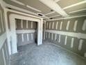 Interior of the room shows freshly installed drywall and tape awaiting paint, and recessed ceiling lights at 1057 Nw 68Th Pl, Ocala, FL 34474