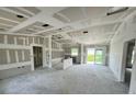 Spacious living room featuring unfinished drywall walls, recessed lighting, and a sliding glass door at 1057 Nw 68Th Pl, Ocala, FL 34474