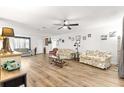 Bright living room boasts wood floors, ceiling fan, and ample space for entertaining at 11245 Sw 63Rd Terrace Rd, Ocala, FL 34476