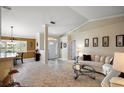 Bright and airy living room featuring tile flooring, large windows, and an open floor plan to the dining area at 13786 Se 88Th Ct, Summerfield, FL 34491