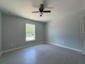 Bedroom featuring a window, ceiling fan and gray tile flooring at 15419 Sw 65Th Terrace Rd, Ocala, FL 34473