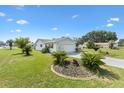 Well-maintained single-story home with a lush green lawn and mature landscaping at 17915 Se 102Nd Ter, Summerfield, FL 34491