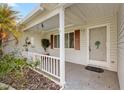 Inviting front porch with a decorative door, charming details, and cozy ambiance at 17915 Se 102Nd Ter, Summerfield, FL 34491