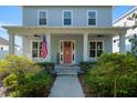 Inviting covered front porch with American flag and seating area at 1906 Se 28Th Pl, Ocala, FL 34471