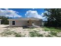 New home showing rear covered porch overlooking the yard at 24128 Sw South Lakes Ct, Dunnellon, FL 34431
