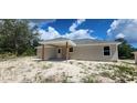 Exterior shot showcasing a covered patio perfect for outdoor relaxation at 24146 Sw South Lakes Ct, Dunnellon, FL 34431