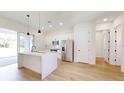 Open kitchen featuring modern appliances, white cabinetry, and a center island with seating at 2438 Sw 165Th Street Rd, Ocala, FL 34473