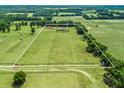 Expansive acreage features a well-maintained home, with lush green fields and mature trees within the property lines at 2540 Ne 120Th St, Anthony, FL 32617