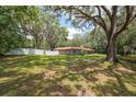 Large backyard with mature trees offering privacy surrounding a ranch-style house at 4010 Sw 7Th Avenue Rd, Ocala, FL 34471
