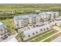 Aerial view of condos with lush landscaping and convenient parking at 420 Bouchelle Dr # 204, New Smyrna Beach, FL 32169