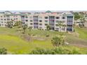 Condo building exterior on lush lawn with tropical palm tree accents at 420 Bouchelle Dr # 204, New Smyrna Beach, FL 32169