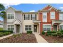 Charming townhome featuring a colorful exterior, well-manicured landscaping, and a welcoming entrance at 4412 Sw 49Th Ave, Ocala, FL 34474