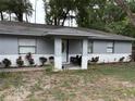 Inviting covered front porch with stylish tile flooring and a cozy seating area at 5549 Nw 64Th St, Ocala, FL 34482