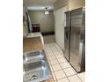 Kitchen with stainless steel appliances, granite countertops, and tile flooring at 5549 Nw 64Th St, Ocala, FL 34482