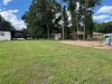 Large backyard featuring mature trees, providing privacy and shade for outdoor enjoyment and gatherings at 5787 Nw 58Th Ter, Ocala, FL 34482