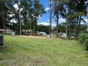 Expansive backyard with mature trees and plenty of space for outdoor activities, perfect for entertaining or relaxing at 5787 Nw 58Th Ter, Ocala, FL 34482
