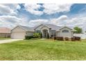 Inviting home with lush landscaping and a well-manicured lawn at 8170 Sw 56Th Avenue Rd, Ocala, FL 34476