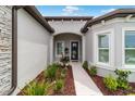 Welcoming entrance with elegant landscaping leading to the front door at 8606 Sw 61St Loop, Ocala, FL 34481