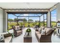 Covered patio with comfortable seating and views of the golf course at 8606 Sw 61St Loop, Ocala, FL 34481