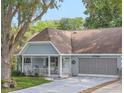 A charming single-story home showcasing a covered porch, attached garage, and well-manicured lawn at 8784 Sw 93Rd Ln # A, Ocala, FL 34481