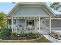 Inviting front porch with seating and a white picket fence, offering a cozy outdoor space at 8784 Sw 93Rd Ln # A, Ocala, FL 34481