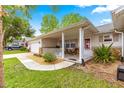 Charming home featuring a well-maintained lawn, a covered porch, and an attached garage at 8874 Sw 95Th St # E, Ocala, FL 34481