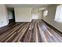 Open-plan living room with updated floors and natural light at 8901 Sw 103Rd Ln, Ocala, FL 34481