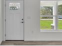 Bright entryway featuring a front door with glass and a view of the outdoors through a window at 904 Nw 67Th St, Ocala, FL 34474