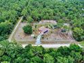 Aerial view of secluded home on acreage, surrounded by lush greenery and a fenced perimeter at 9325 Sw 125Th Court Rd, Dunnellon, FL 34432