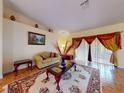 Cozy living room featuring a decorative rug, comfortable seating, and bright, neutral walls at 9325 Sw 125Th Court Rd, Dunnellon, FL 34432
