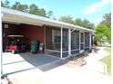 Spacious garage featuring a golf cart and ample storage space; the screened porch is located adjacent at 9430 Sw 102Nd Pl, Ocala, FL 34481