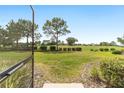 View of the lush backyard from the screened patio, with a well-maintained lawn and landscaping at 9839 Sw 90Th St, Ocala, FL 34481