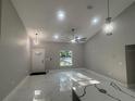 Bright living room with high ceilings, recessed lights, decorative fans, and glossy marble floors at 14540 Se 33Rd Ter, Summerfield, FL 34491