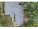 Aerial view of a home with a large roof, mature trees, and landscaped yard offering a private setting at 15324 Sw 28Th Avenue Rd, Ocala, FL 34473